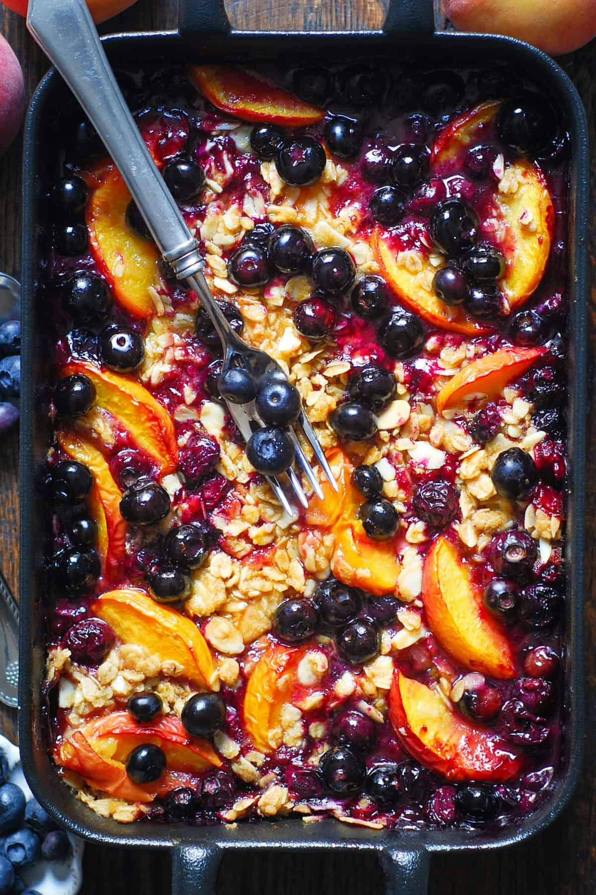 Peach and Blueberry Crisp with Almonds, Oats, and Brown Sugar. 