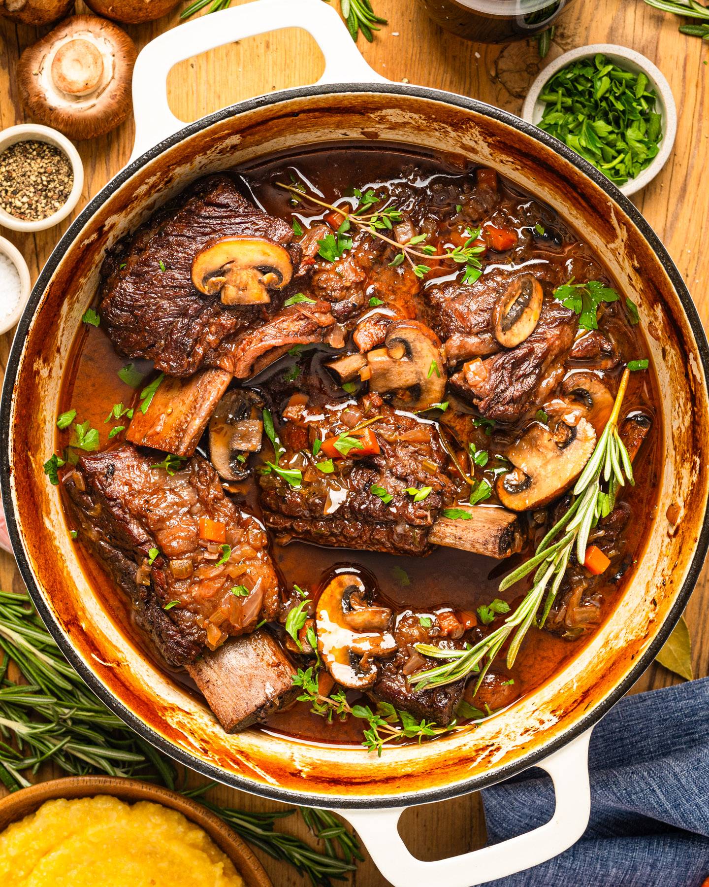 Braised Short Ribs with Red Wine Sauce, Mushrooms in a Dutch oven.