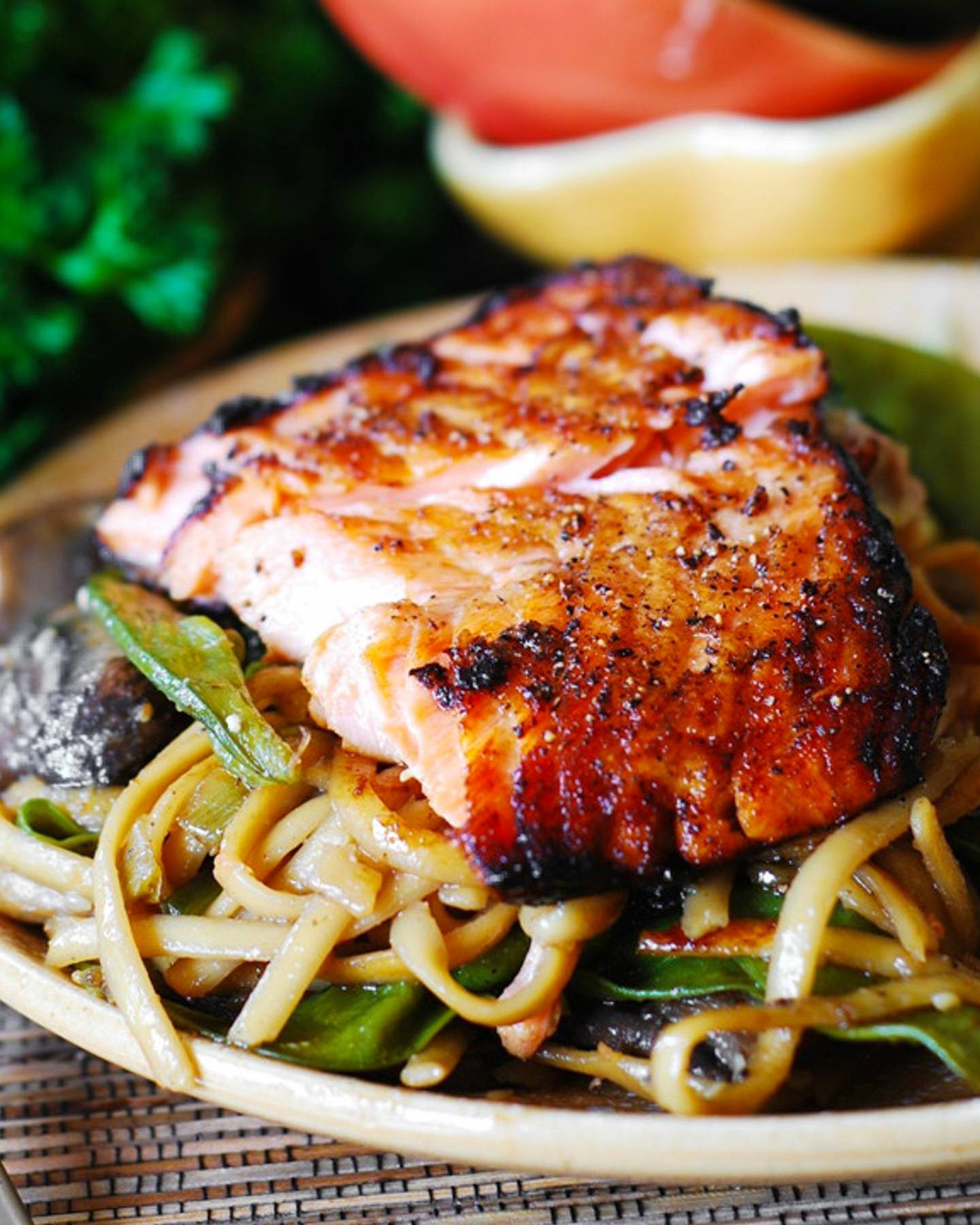 Asian Salmon with Noodles, Mushrooms, and Snap Peas on a plate.