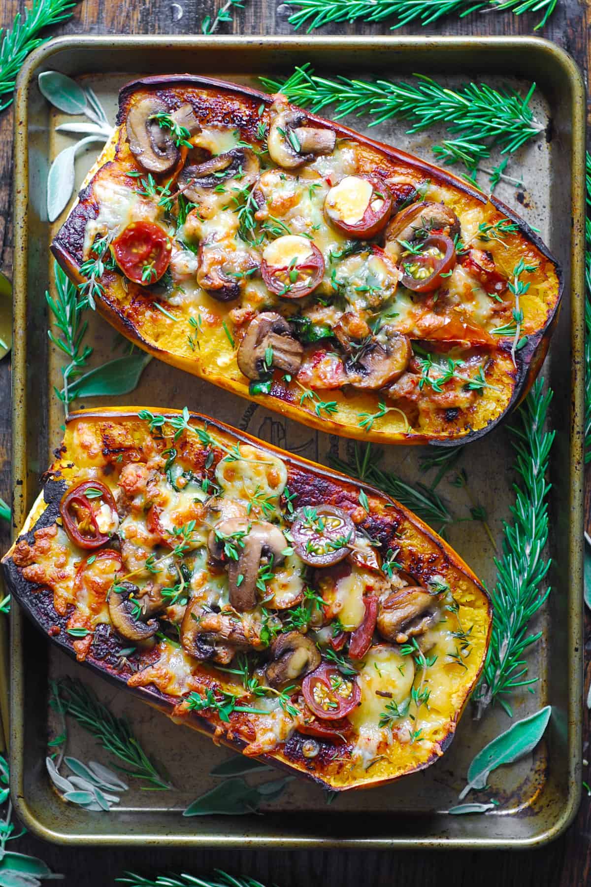 Italian Sausage Stuffed Spaghetti Squash with Spinach, Tomatoes, and Mushrooms - on a baking sheet.