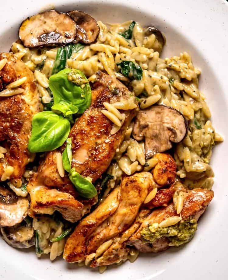 Creamy Chicken Orzo with Mushrooms, Spinach, and Basil Pesto - on a plate.