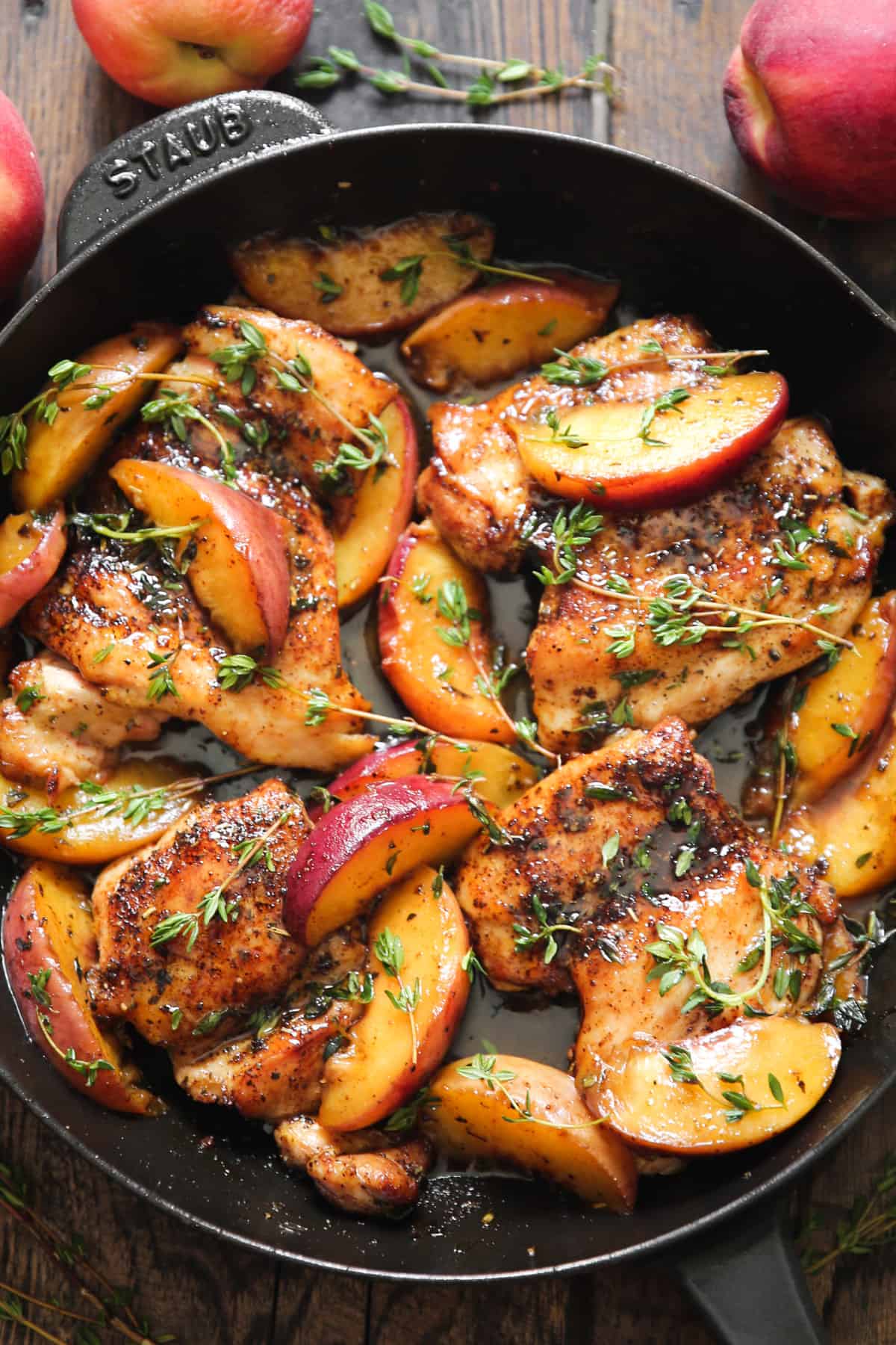Chicken with Peaches and Lemon-Honey Fresh Thyme Sauce in a cast iron skillet.
