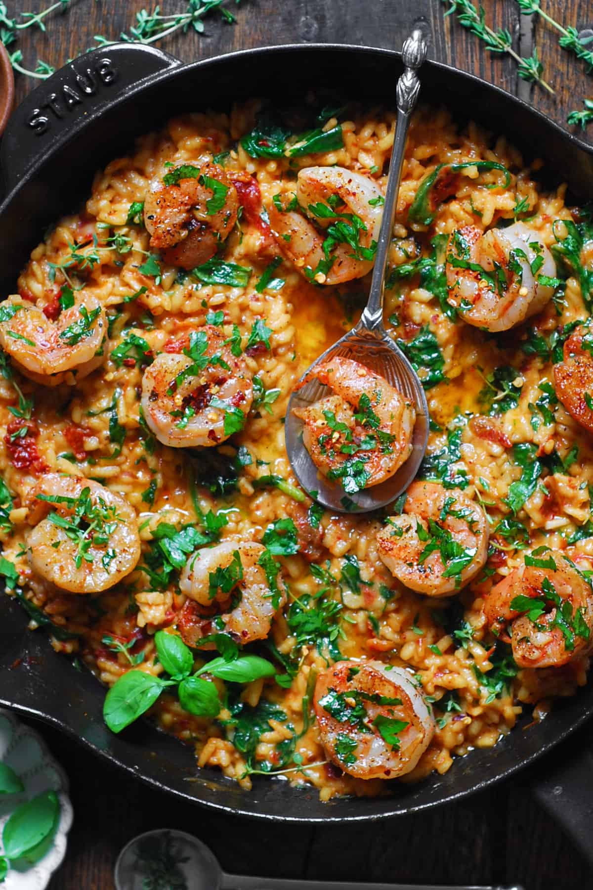 Shrimp Risotto with Spinach and Sun-Dried Tomatoes in a cast iron skillet.