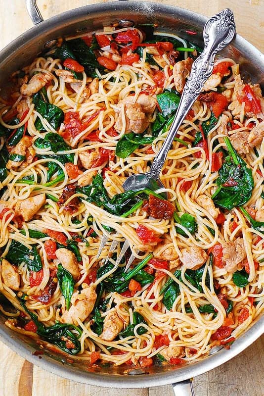 Tomato Spinach Chicken Spaghetti in a stainless steel pan.