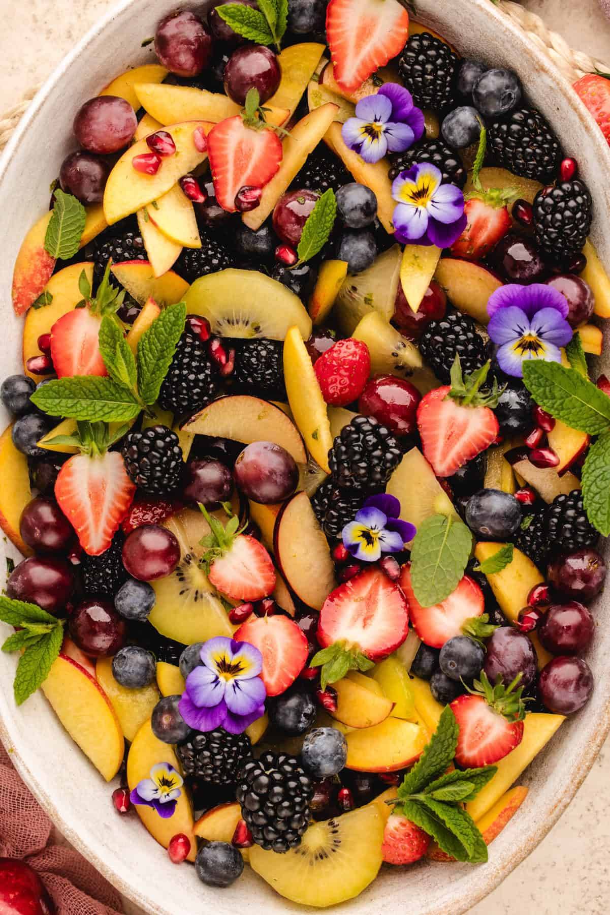 Summer Fruit Salad with Mint-Lime-Honey Dressing in a large white platter.