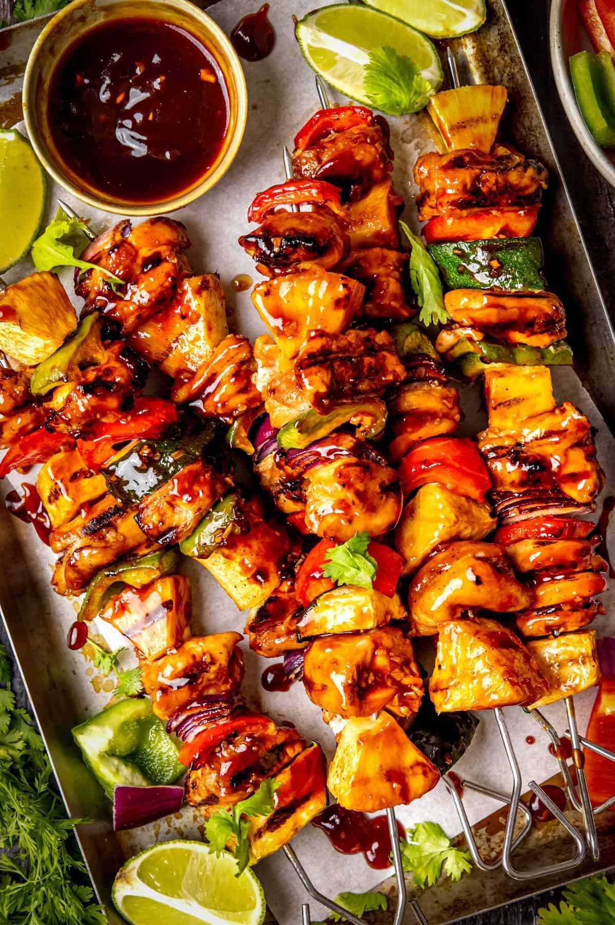 Hawaiian Grilled Teriyaki Chicken Pineapple-Veggie Skewers on a sheet pan.