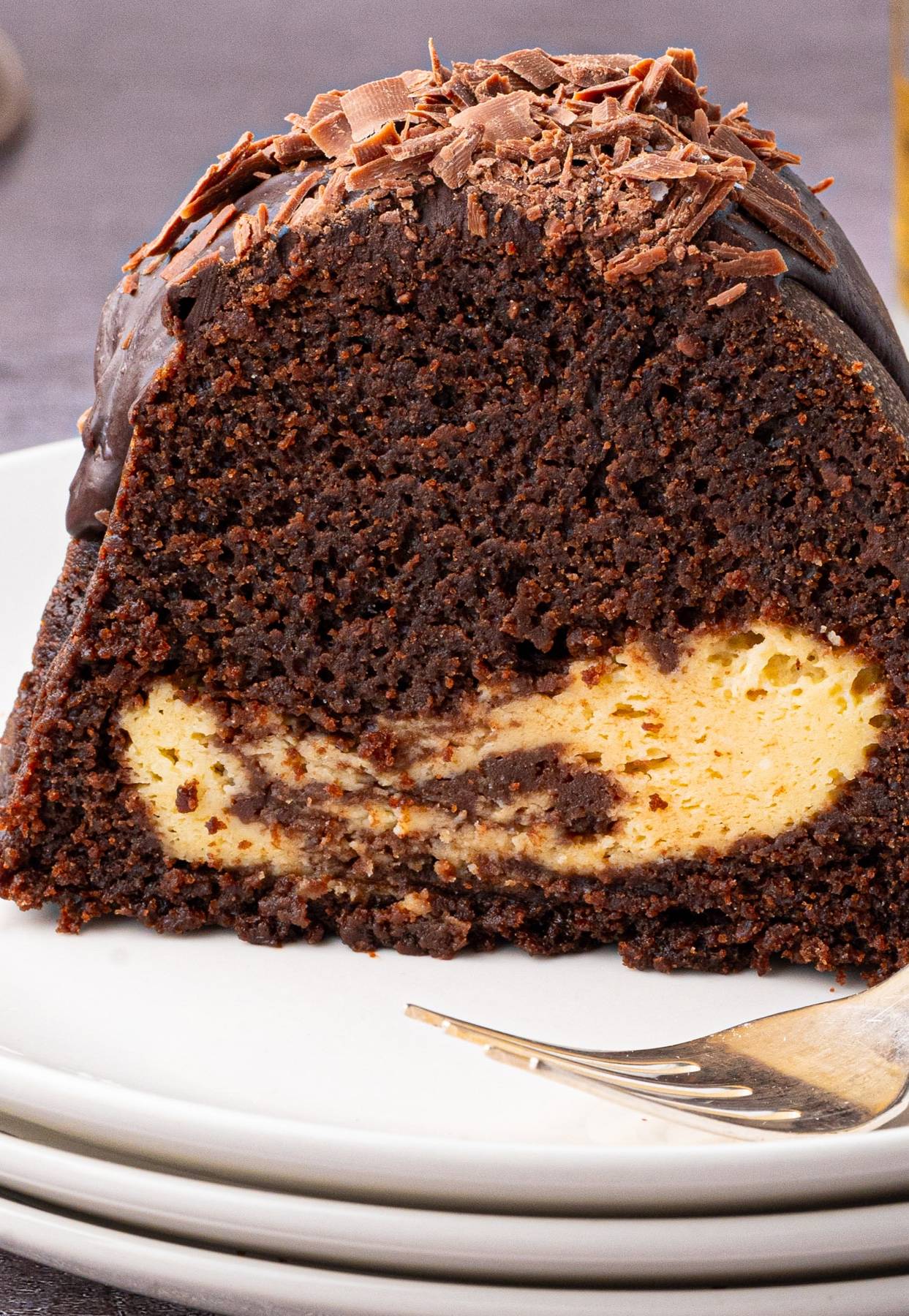 A slice of Guinness Chocolate Bundt Cake (with Baileys Irish Cream Cheesecake Filling) on a plate.