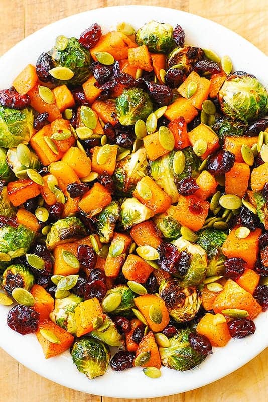 Roasted Brussels Sprouts Salad with Maple Butternut Squash, Pumpkin Seeds, and Cranberries on a plate.