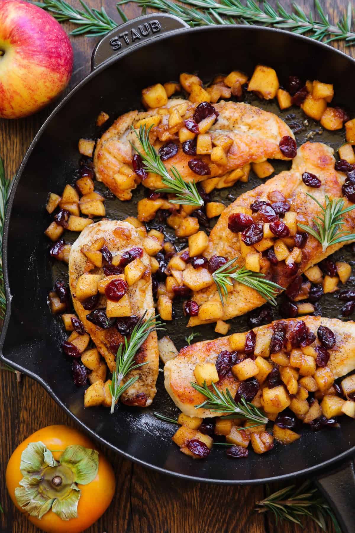 Apple Cranberry Chicken in a cast iron pan.