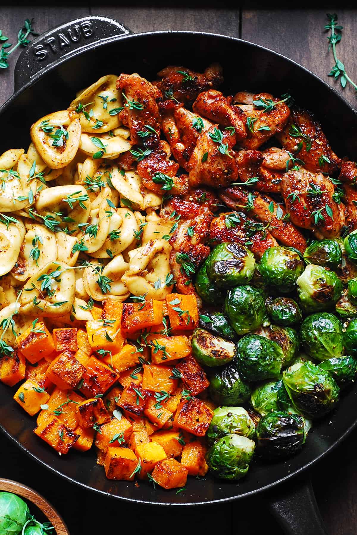 Autumn Chicken Dinner with Roasted Vegetables and Tortellini in a cast iron skillet.
