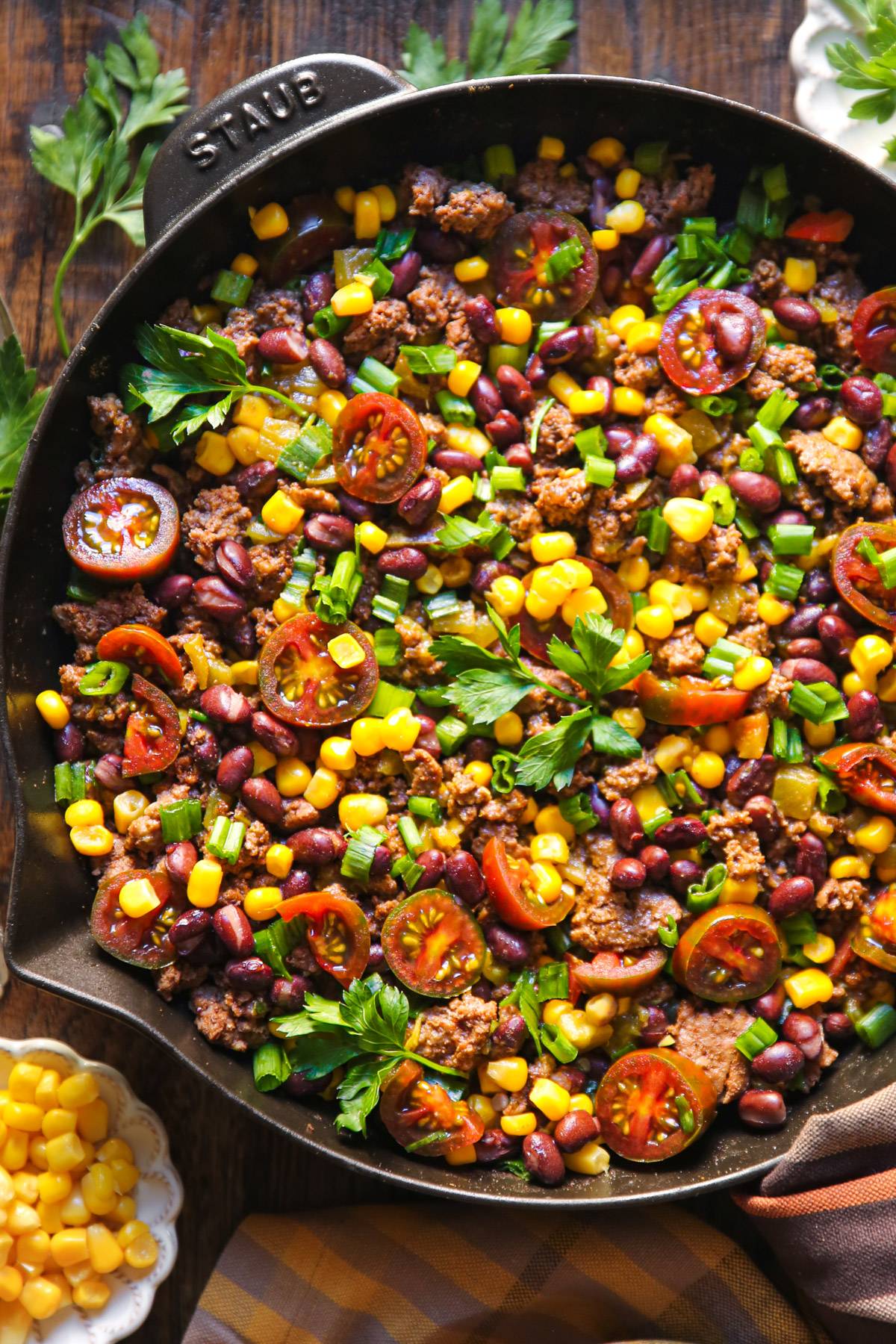Mexican Ground Beef with Tomatoes, Beans, Corn, and Cilantro - in a cast iron skillet.