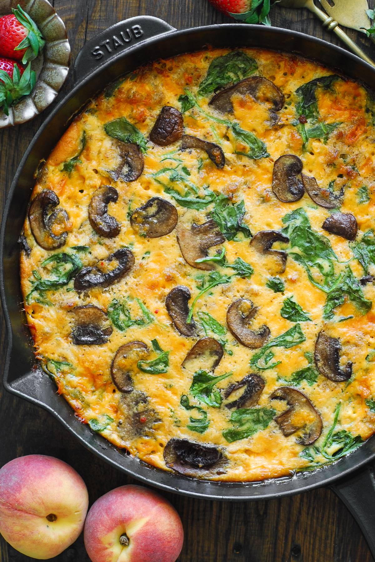 Sausage Frittata with Spinach and Mushrooms in a cast iron skillet.