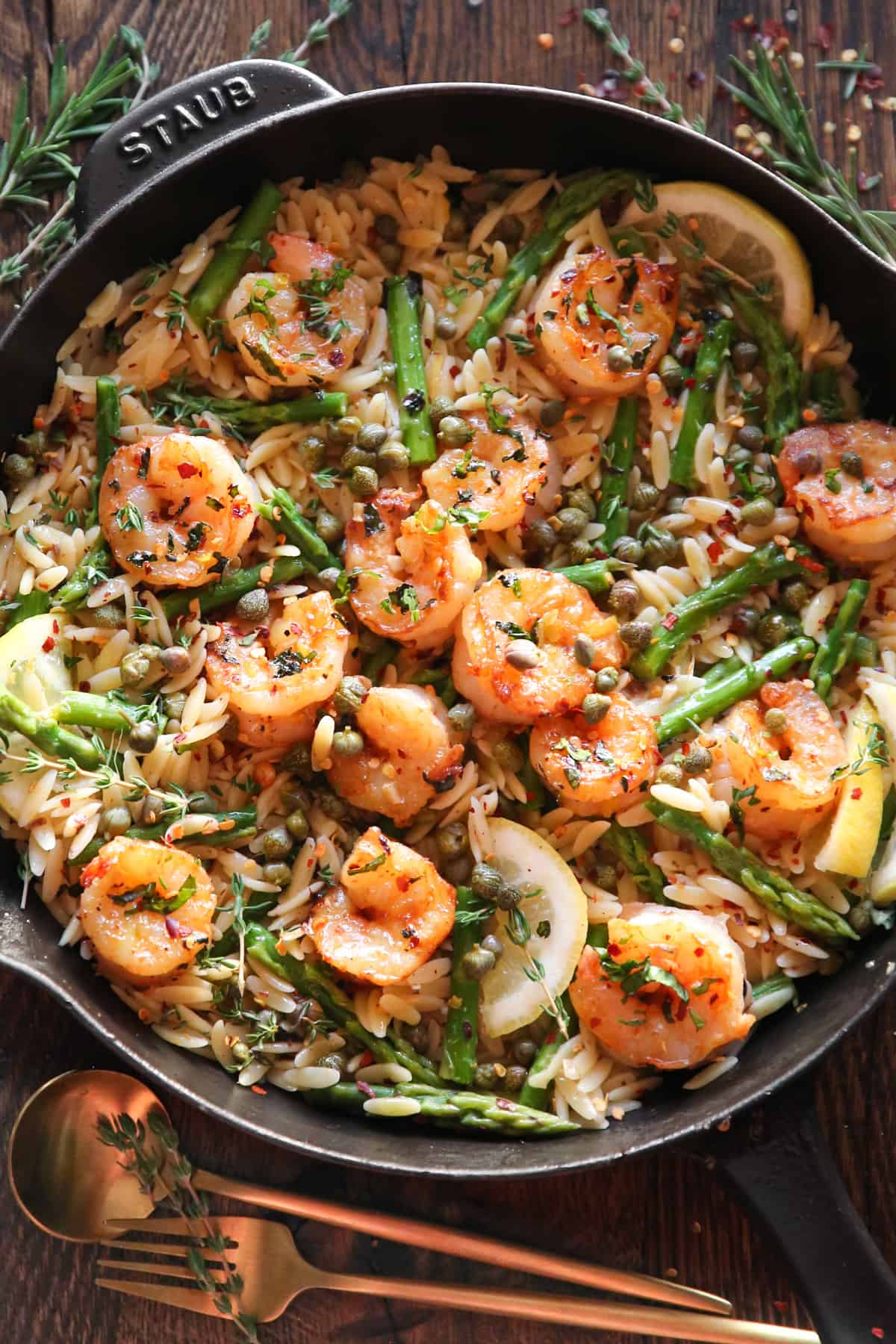 Shrimp Piccata Orzo with Asparagus, Lemon, and Capers in a cast iron skillet.