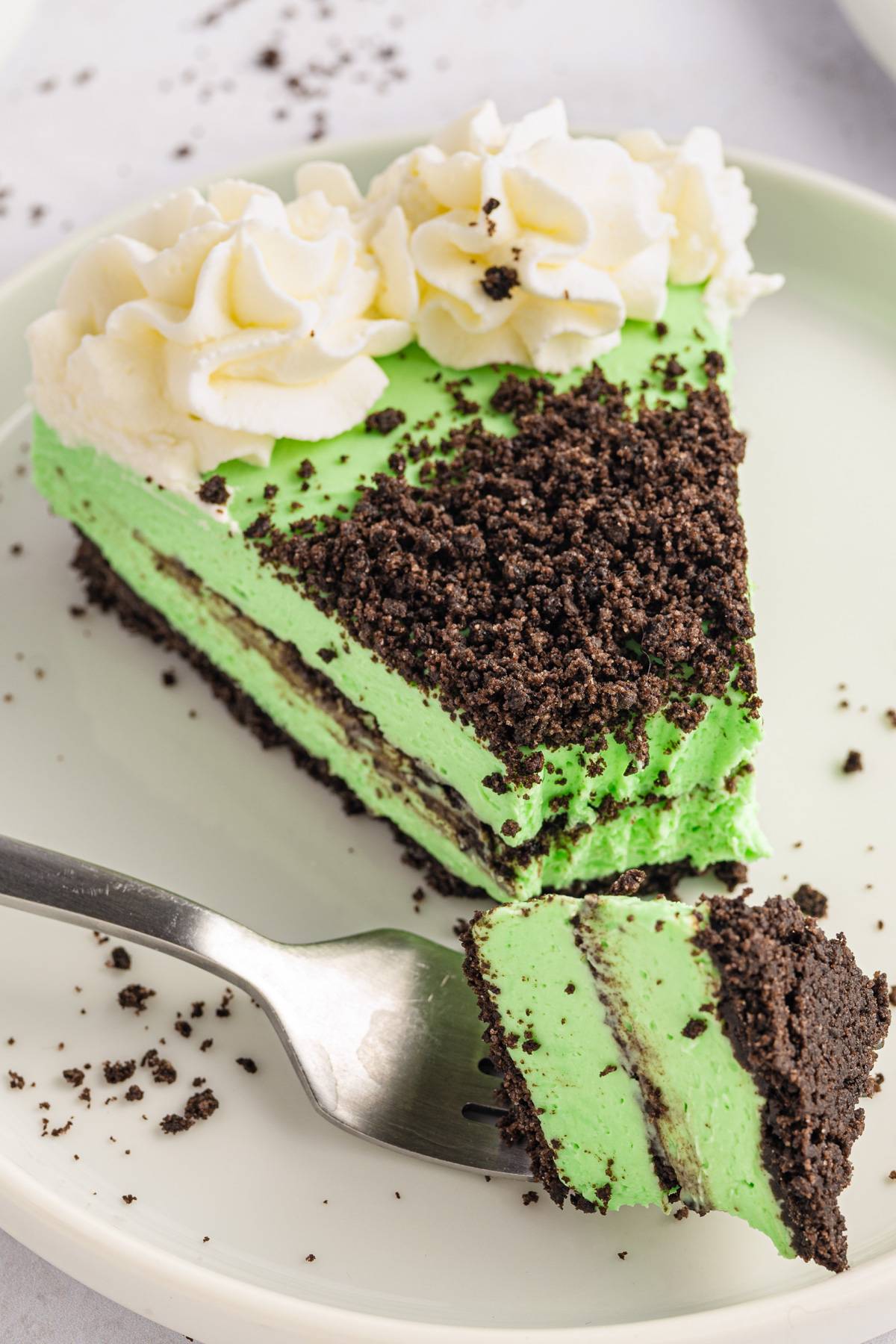 A slice of Grasshopper Cheesecake on a plate.