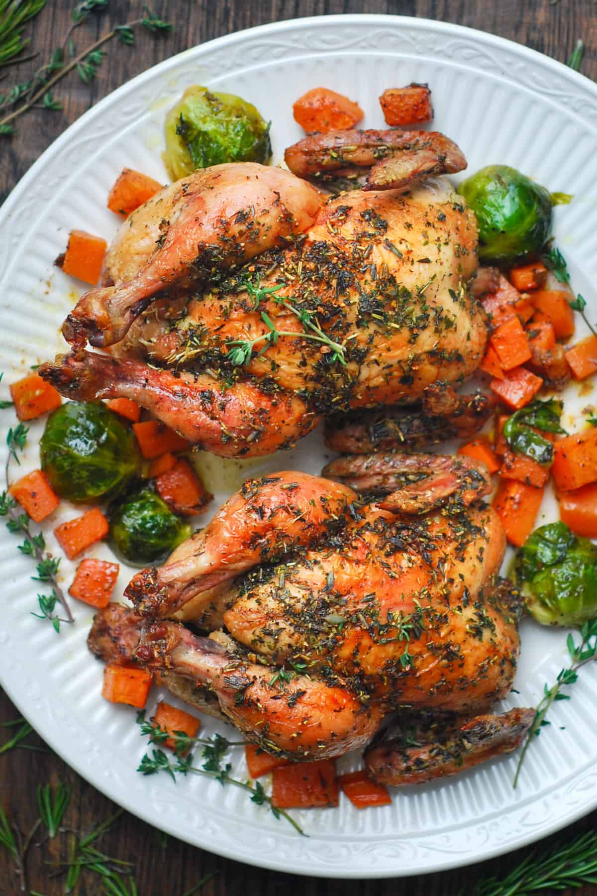 Roasted Cornish Hens with Brussels Sprouts, Sweet Potatoes, and Herb Butter.