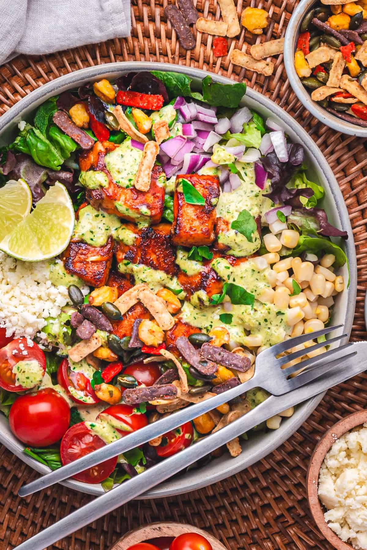 Mexican Salmon Salad Bowl with Corn, Tomatoes, Lettuce in a bowl.