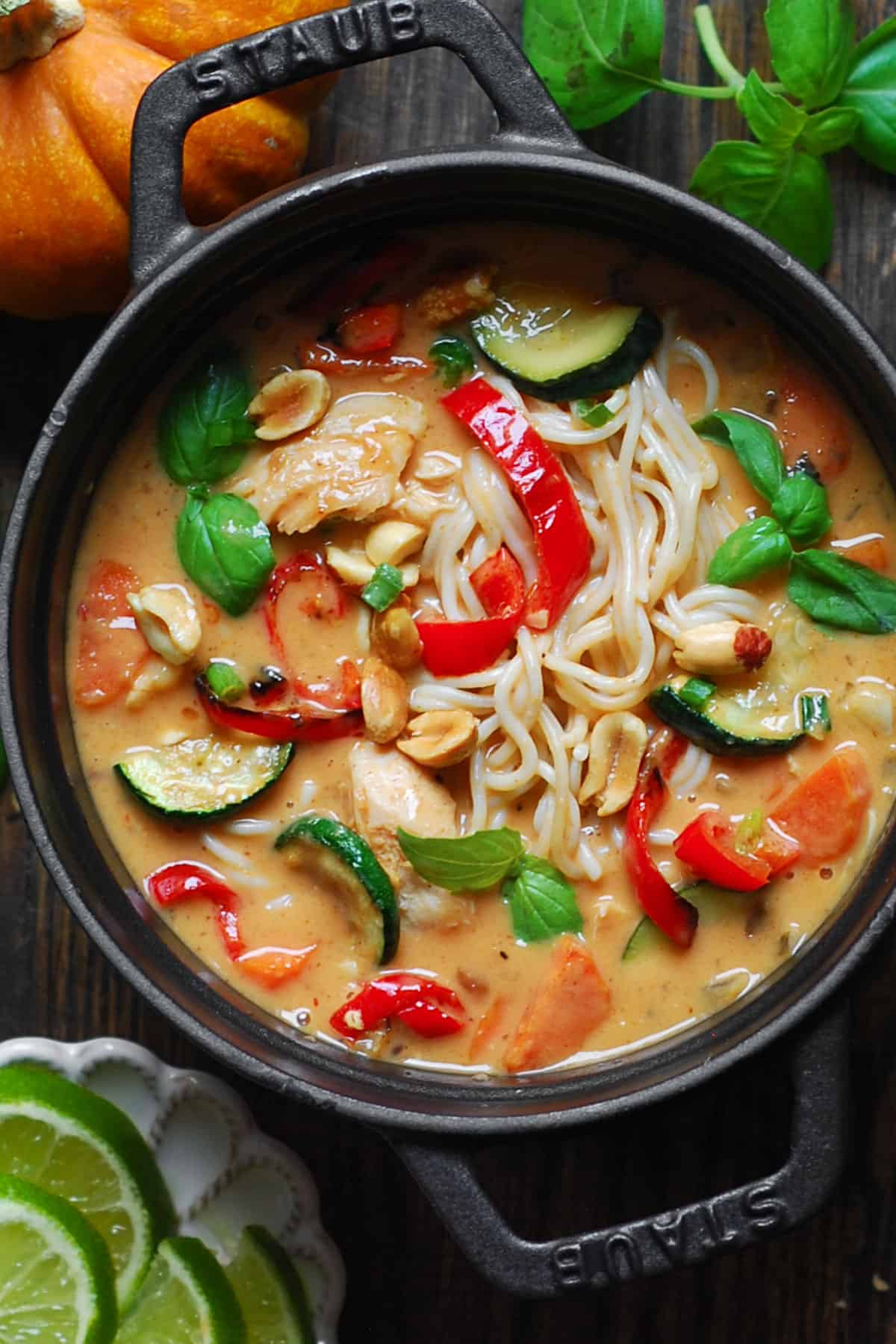 Thai Red Curry Chicken Noodle Soup with Veggies  (bell peppers, zucchini, carrots, onions) - in a small cast-iron pan.