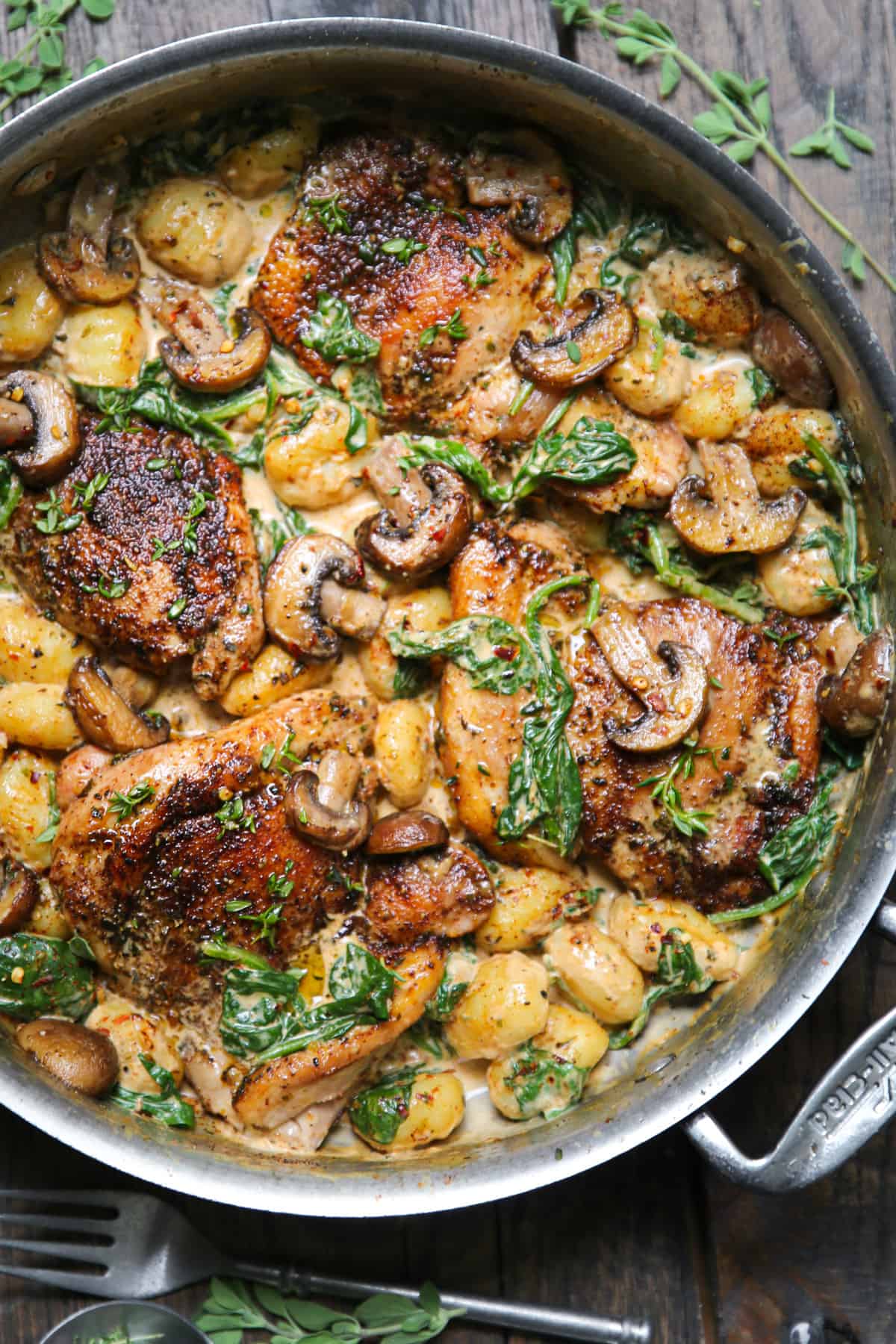 Creamy Chicken and Gnocchi with Spinach, Mushrooms, and Garlic Smoked Paprika Sauce in a stainless steel pan.
