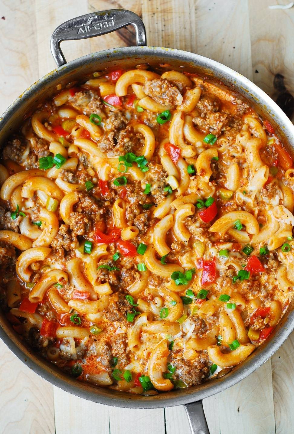 Mac and Cheese with Sausage and Bell Peppers in a stainless steel pan.