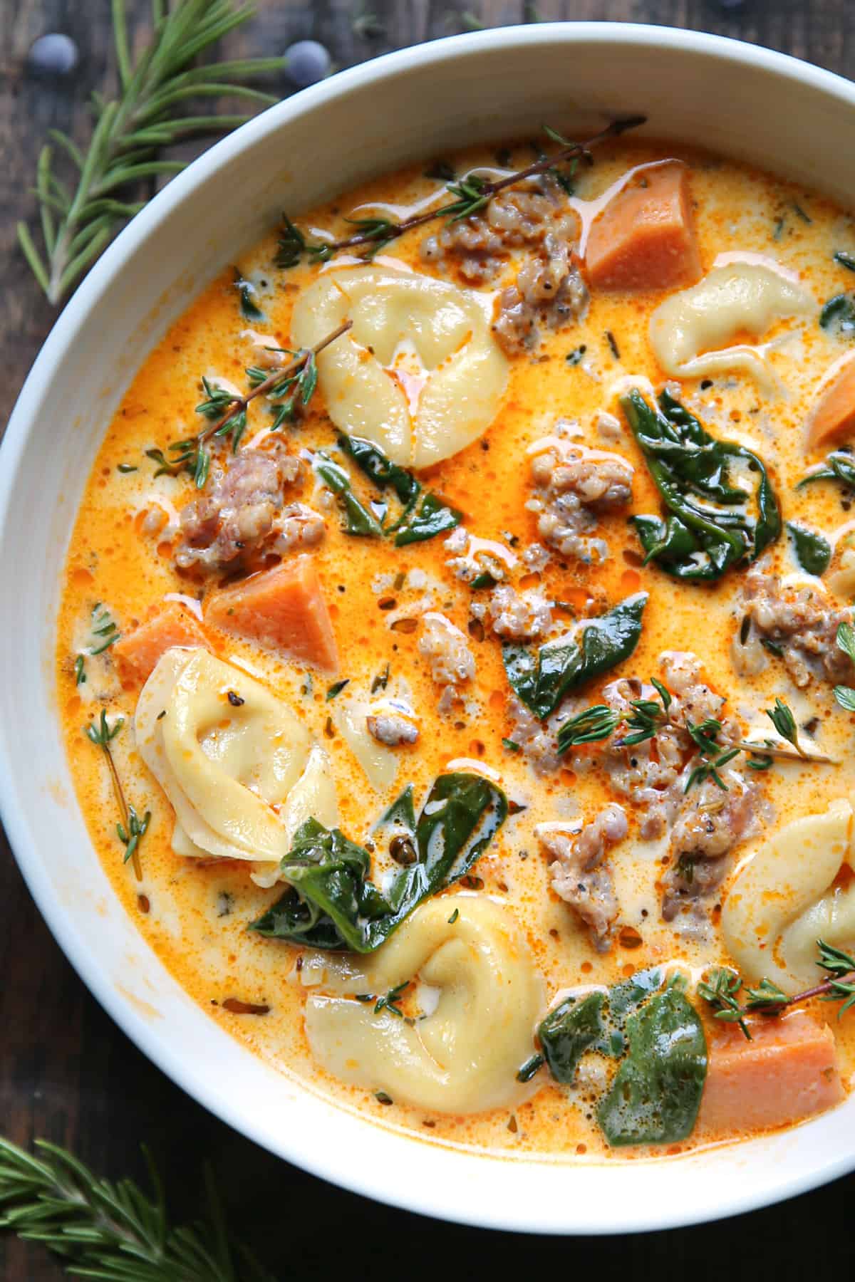 Creamy Sausage Tortellini Soup in a white bowl.