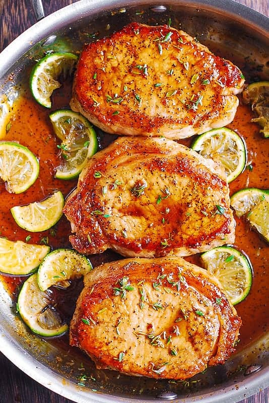 Pan-Fried Pork Chops with Honey Lime Glaze - in a stainless steel pan.