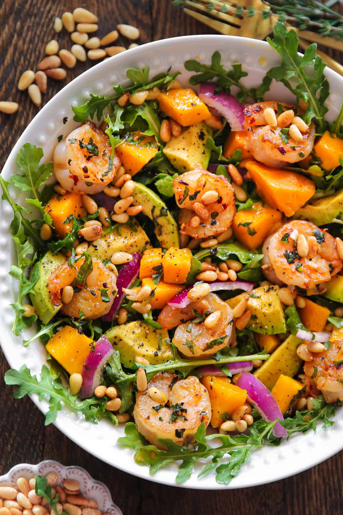 Shrimp Avocado Salad with Mango and Arugula in a bowl.