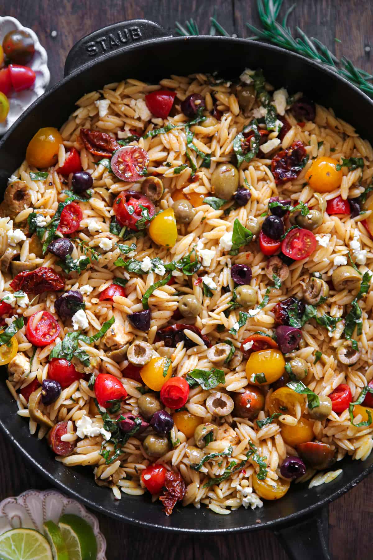 Greek Orzo with Tomatoes, Olives, and Feta Cheese - in a cast iron skillet.