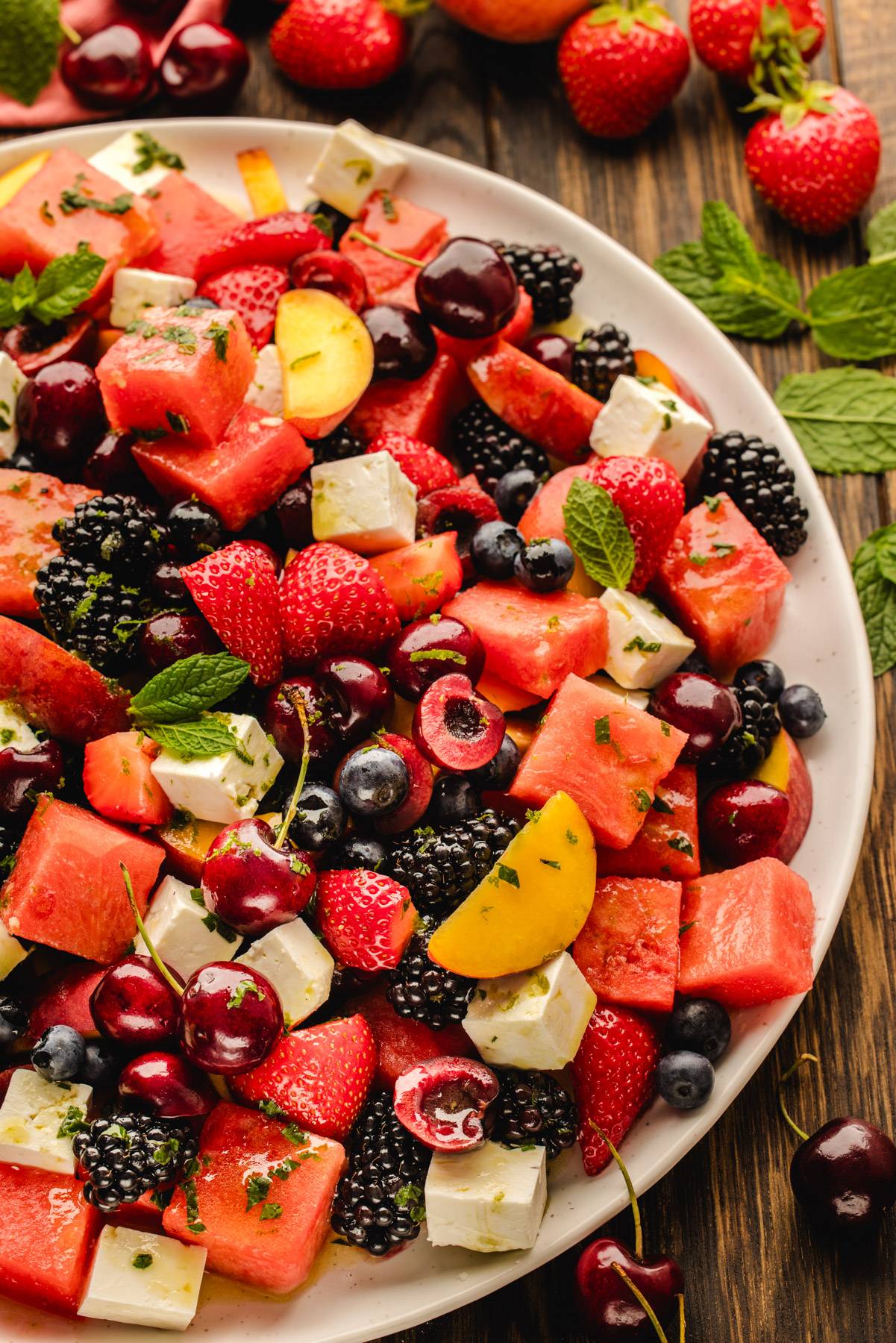 Summer Fruit Salad with Watermelon and Feta on a white plate.