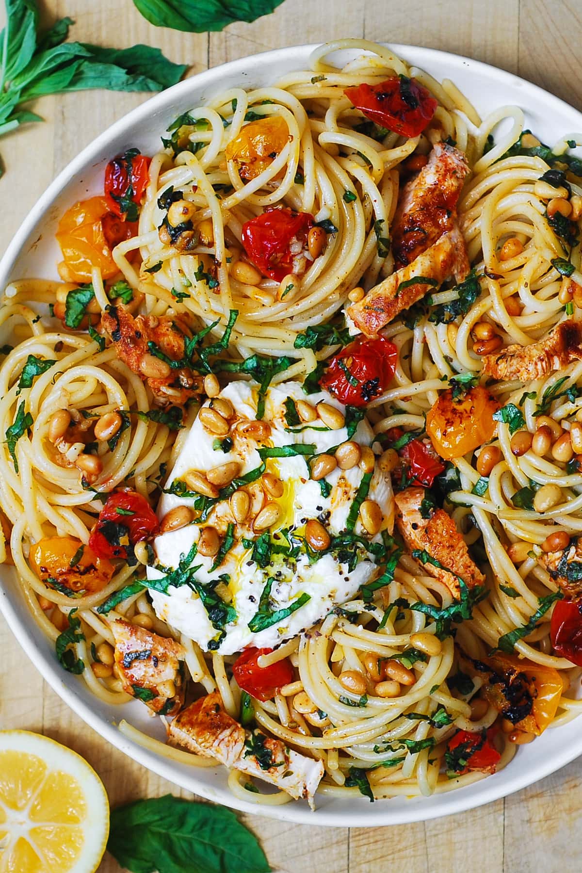 Chicken Spaghetti with Burrata Cheese, Cherry Tomatoes, Pine Nuts, and Lemon Butter Garlic Sauce - on a plate.