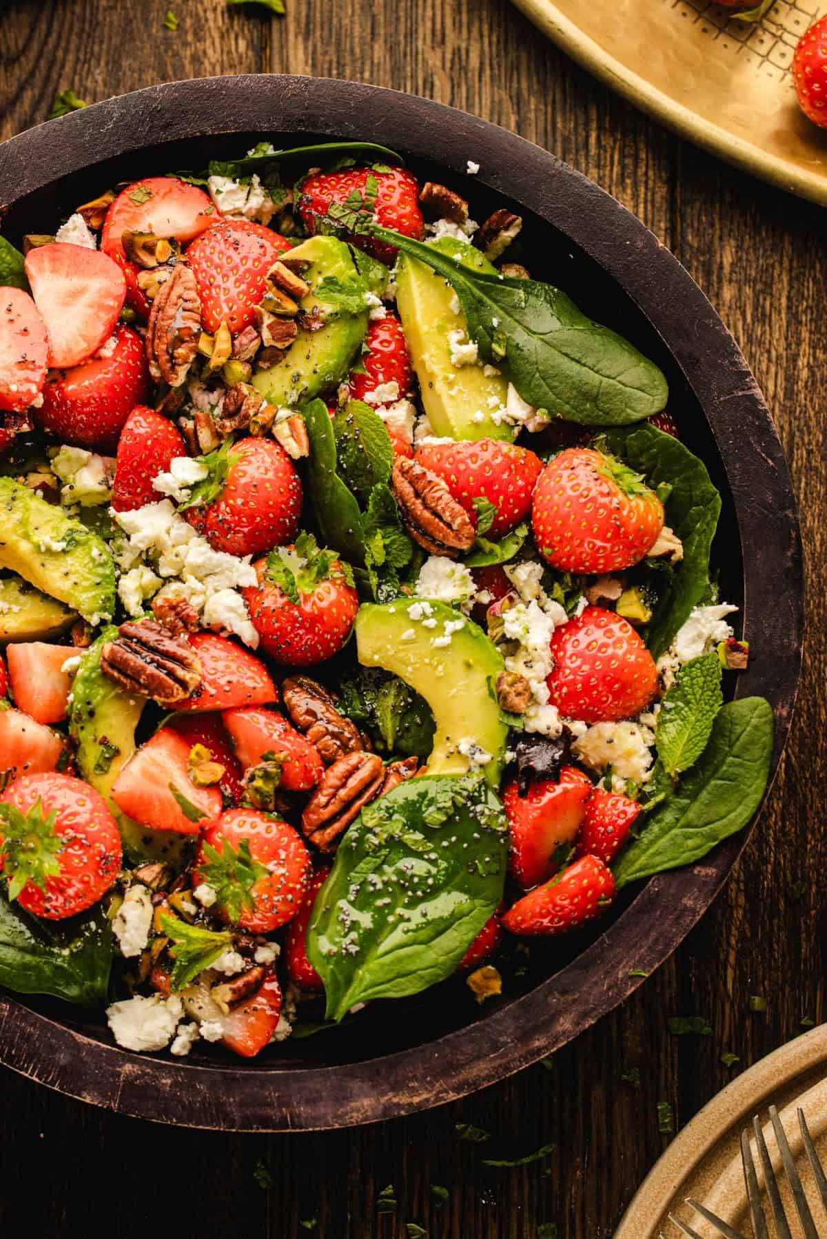 Strawberry Spinach Salad with Poppy Seed Dressing in a wooden bowl.
