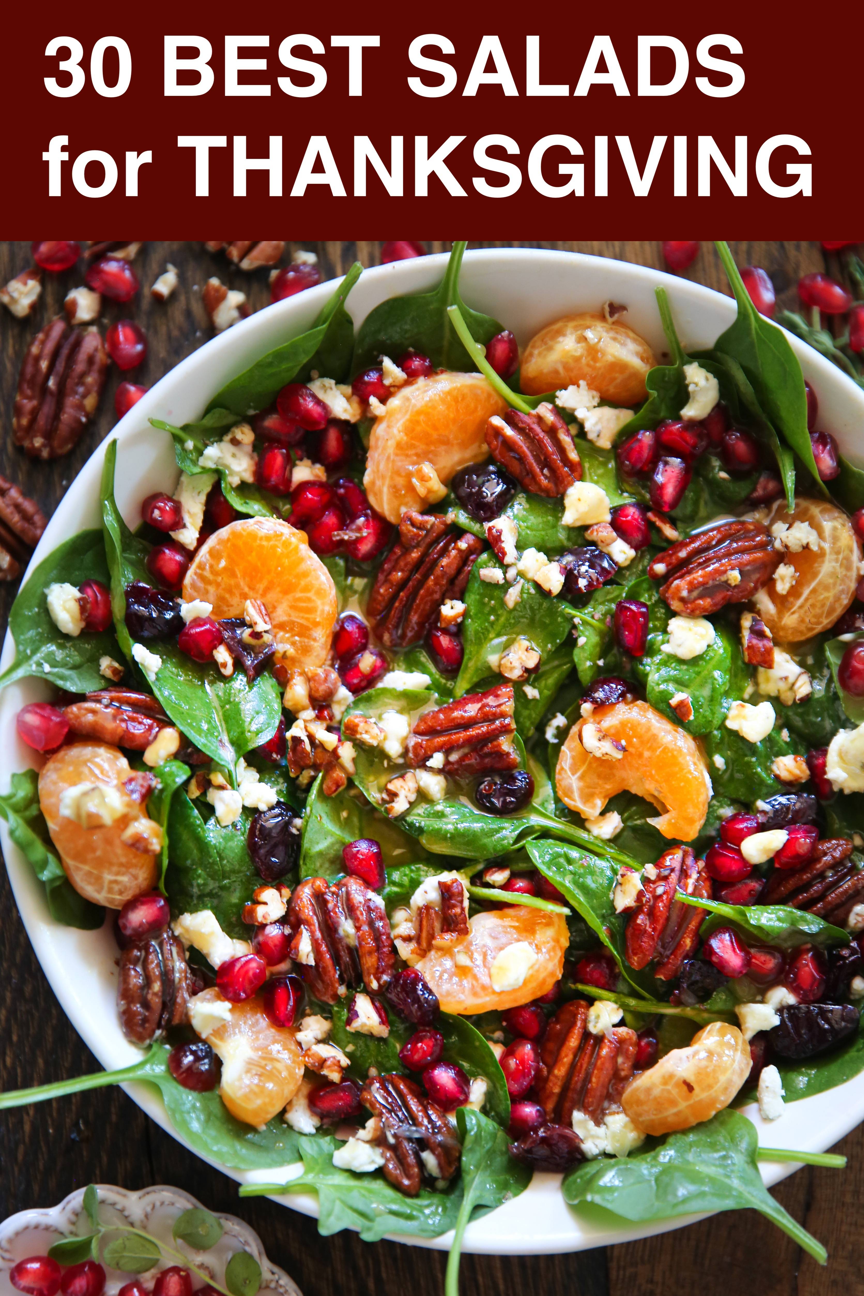 30 Best Thanksgiving Salads - this is written over the photo of the spinach salad with mandarin oranges, pecans, dried cranberries, pomegranate arils, and feta cheese.