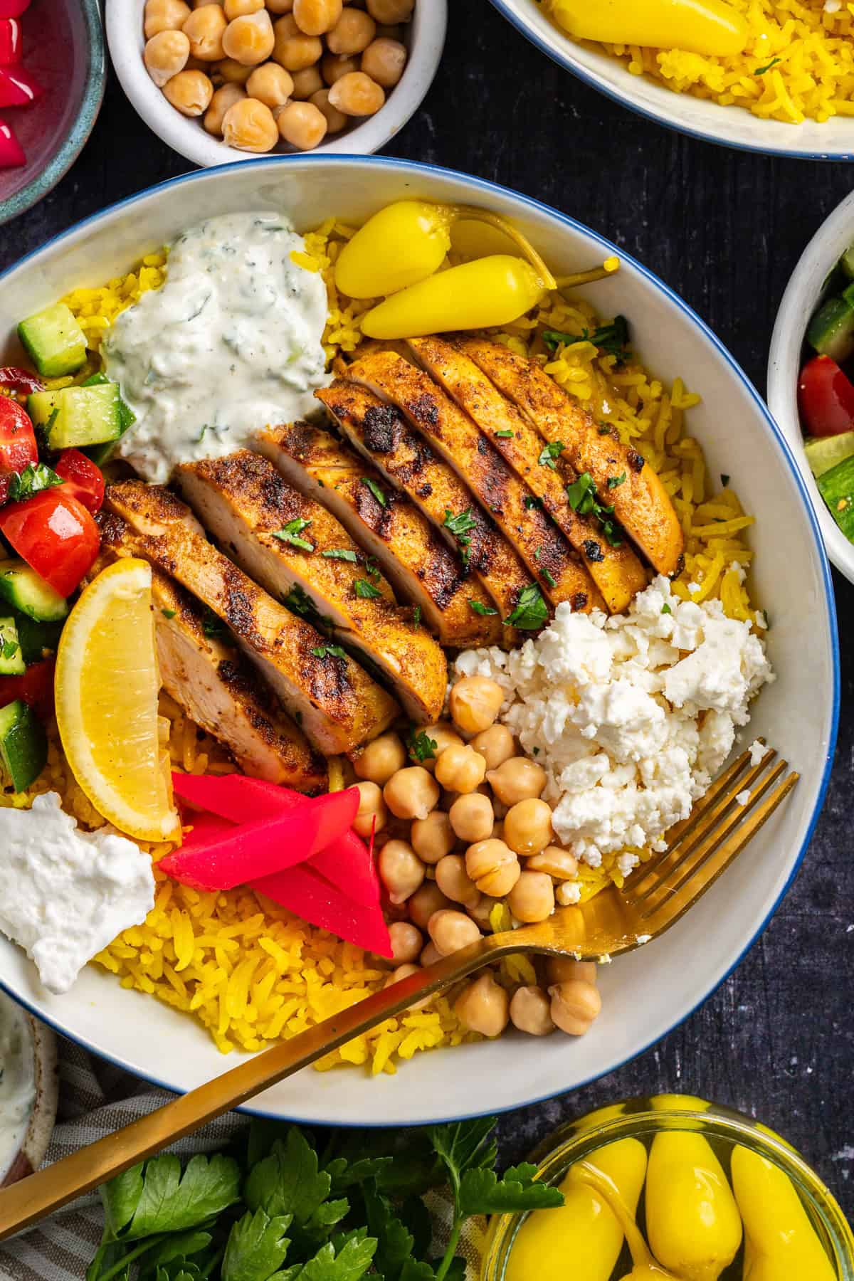 Chicken Shawarma Bowl (with turmeric rice, feta, chickpeas, homemade tzatziki, and fresh tomato-cucumber salad).
