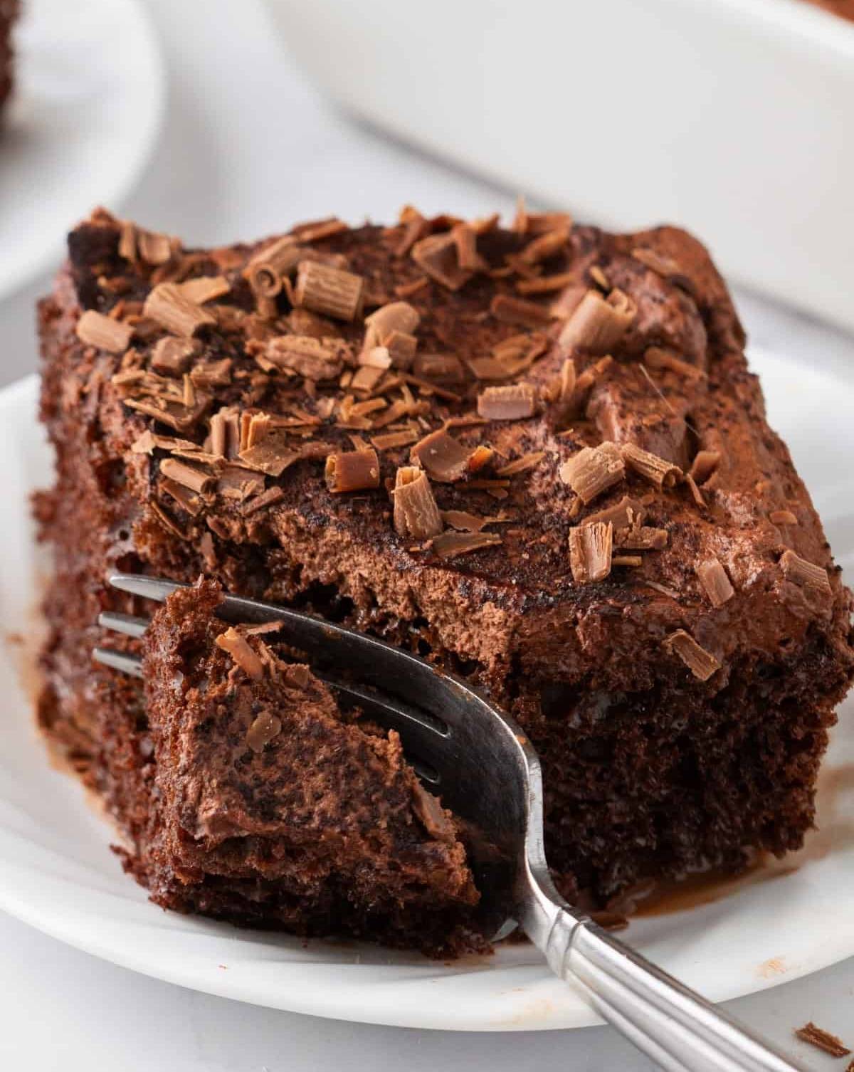 A slice of Chocolate Tres Leches Cake on a plate.