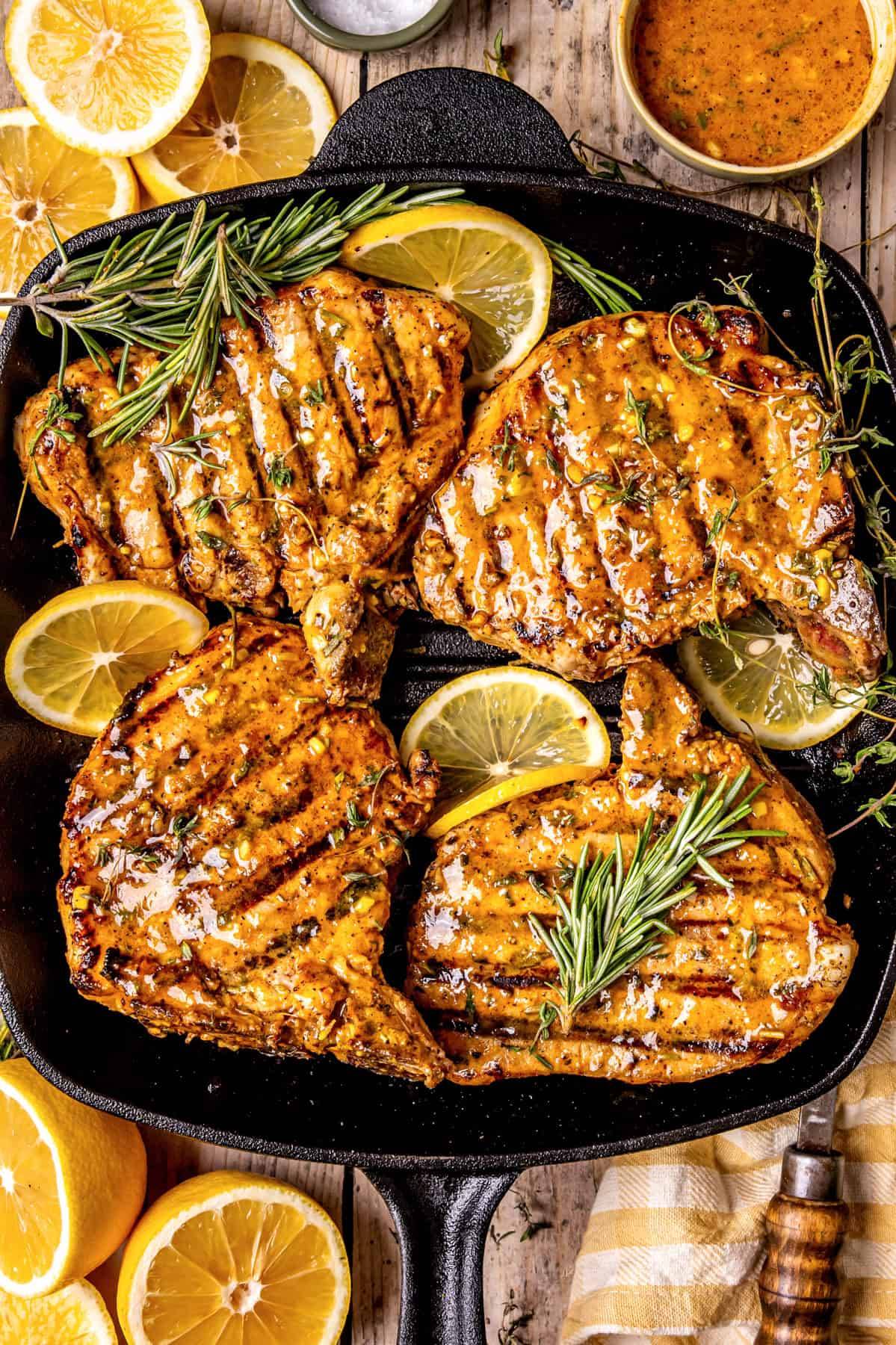 Grilled Pork Chops with Dijon-Honey Herb Marinade in a cast iron grill pan.