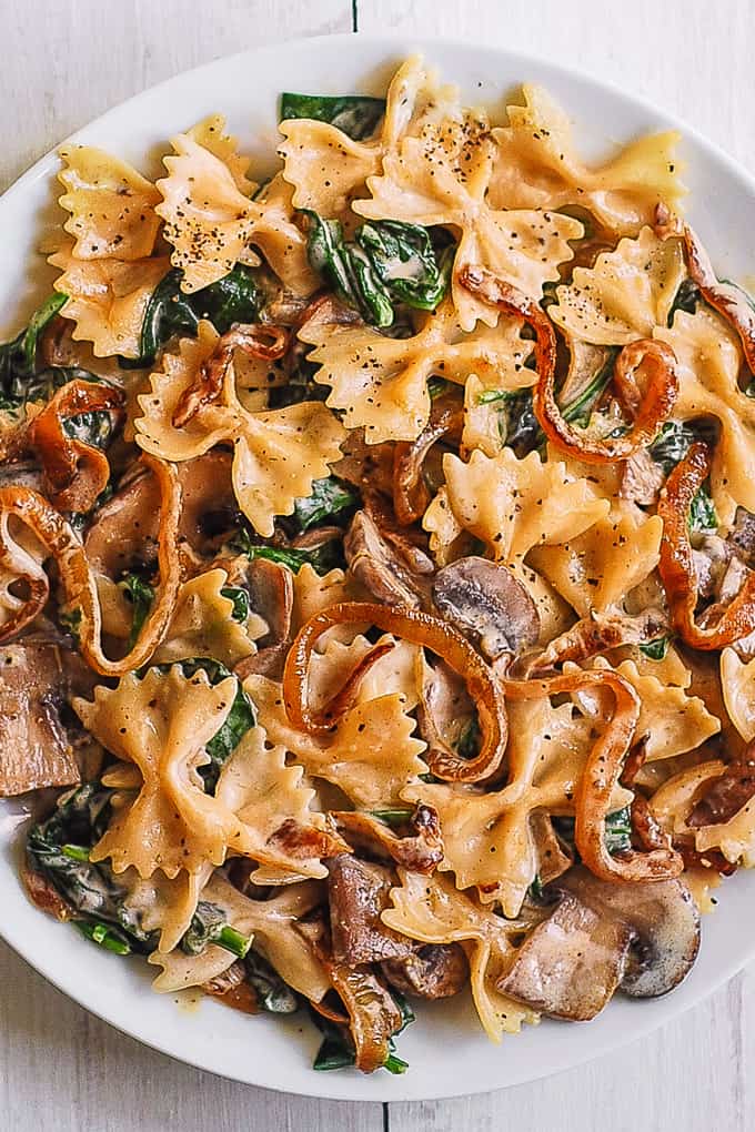 Creamy Farfalle Pasta with Spinach, Mushrooms, and Caramelized Onions. 