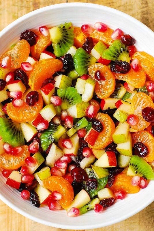 Winter Fruit Salad with Maple-Lime Dressing in a white bowl.