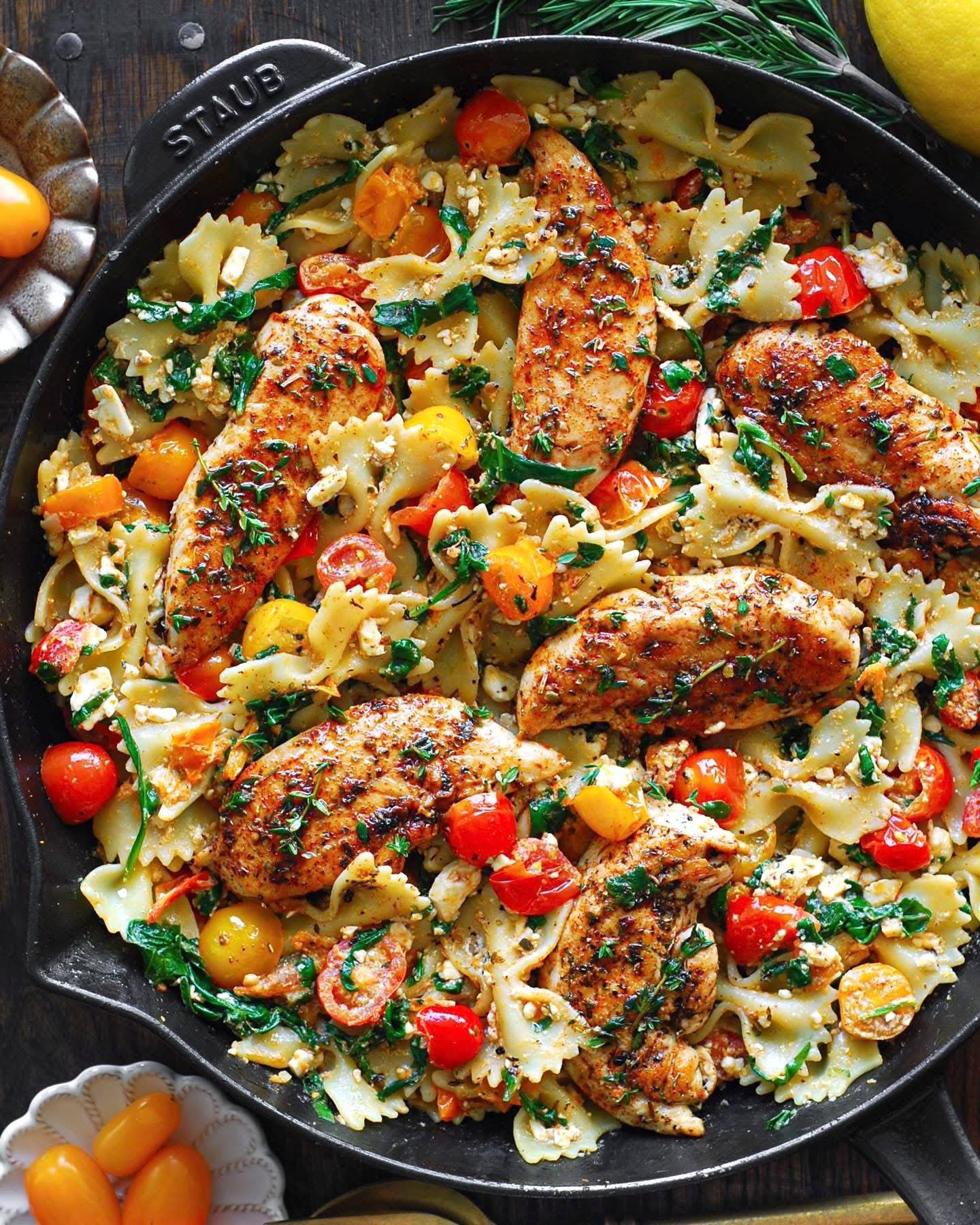 Chicken Feta Pasta with Cherry Tomatoes and Bow-Tie Pasta - in a cast iron skillet.