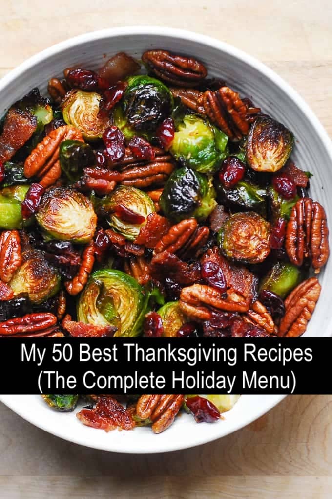 50 Best Thanksgiving Recipes (The Complete Holiday Menu) is written over the photo with roasted Brussels sprouts, pecans, cranberries, and bacon.