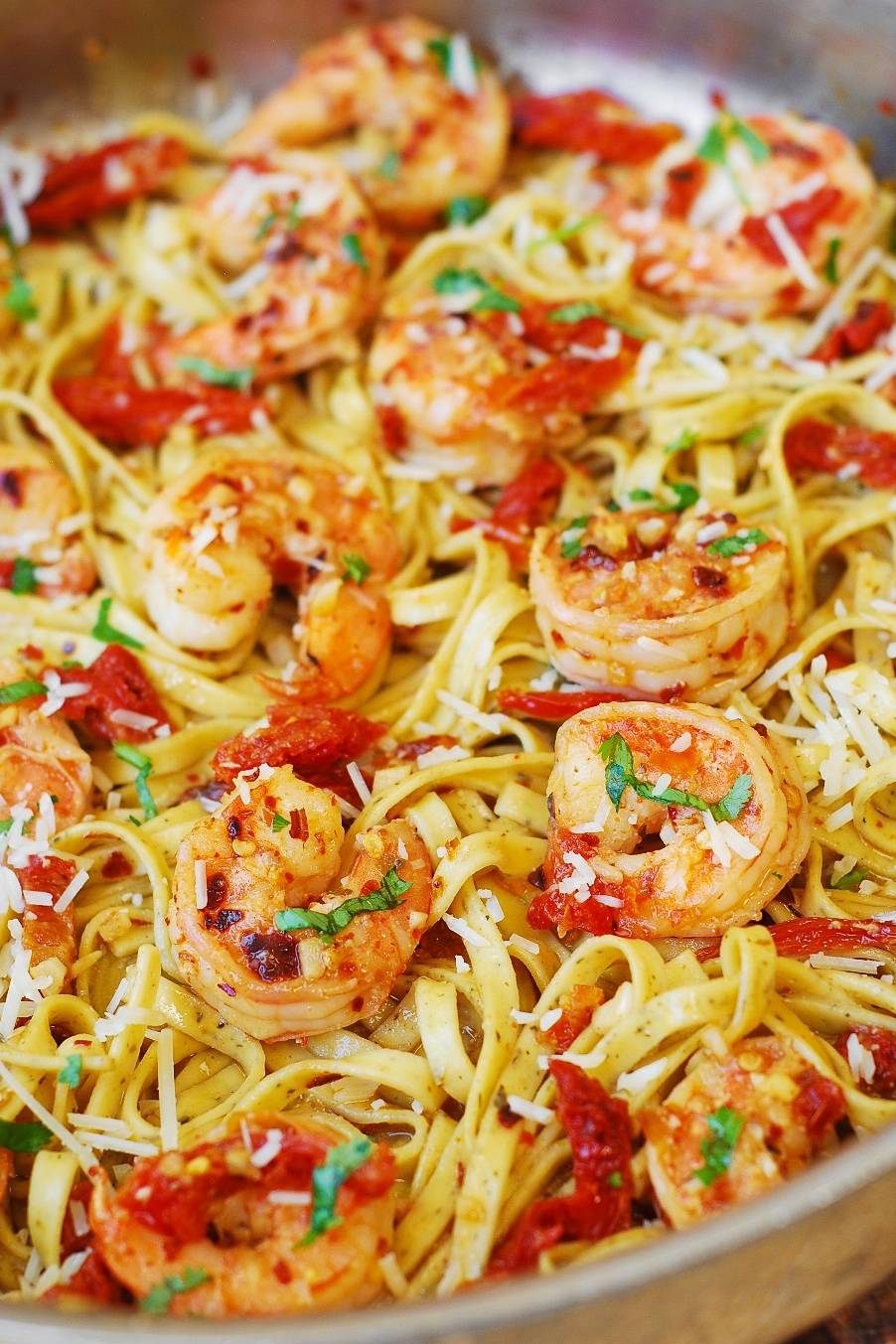 Shrimp Scampi Linguine Pasta with Sun-Dried Tomatoes in a stainless steel pan.