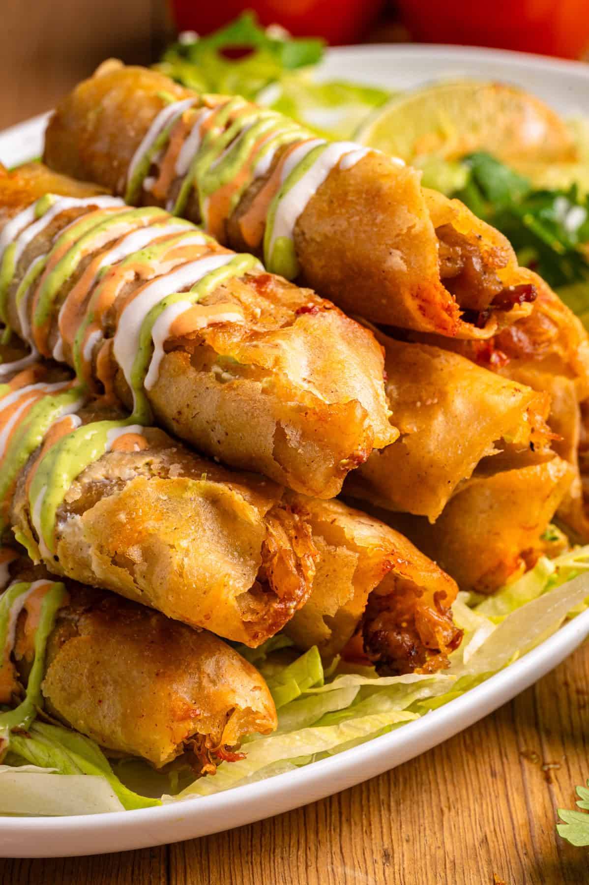 Baked Chicken Taquitos with 3 Sauces on a plate.