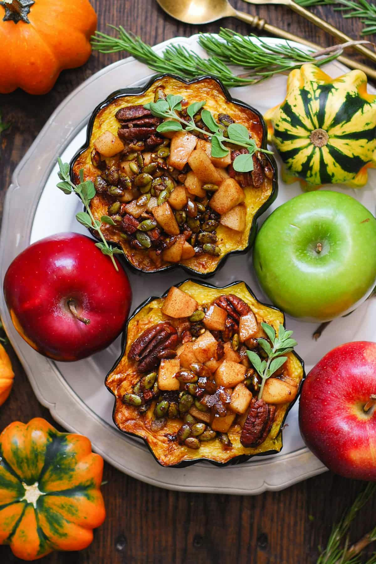 Stuffed Acorn Squash with Maple-Cinnamon Apples, Pecans, and Pumpkin Seeds.