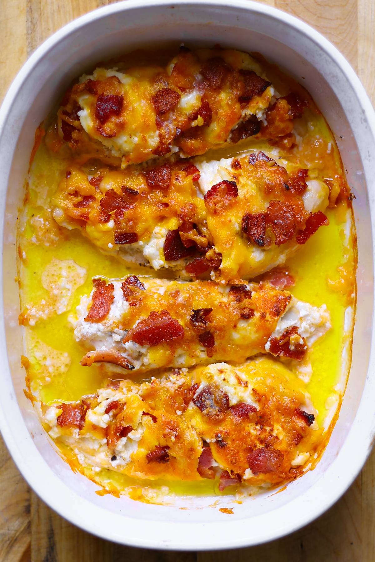 Bacon, Cream Cheese, Cheddar Chicken Breasts in a white casserole dish.