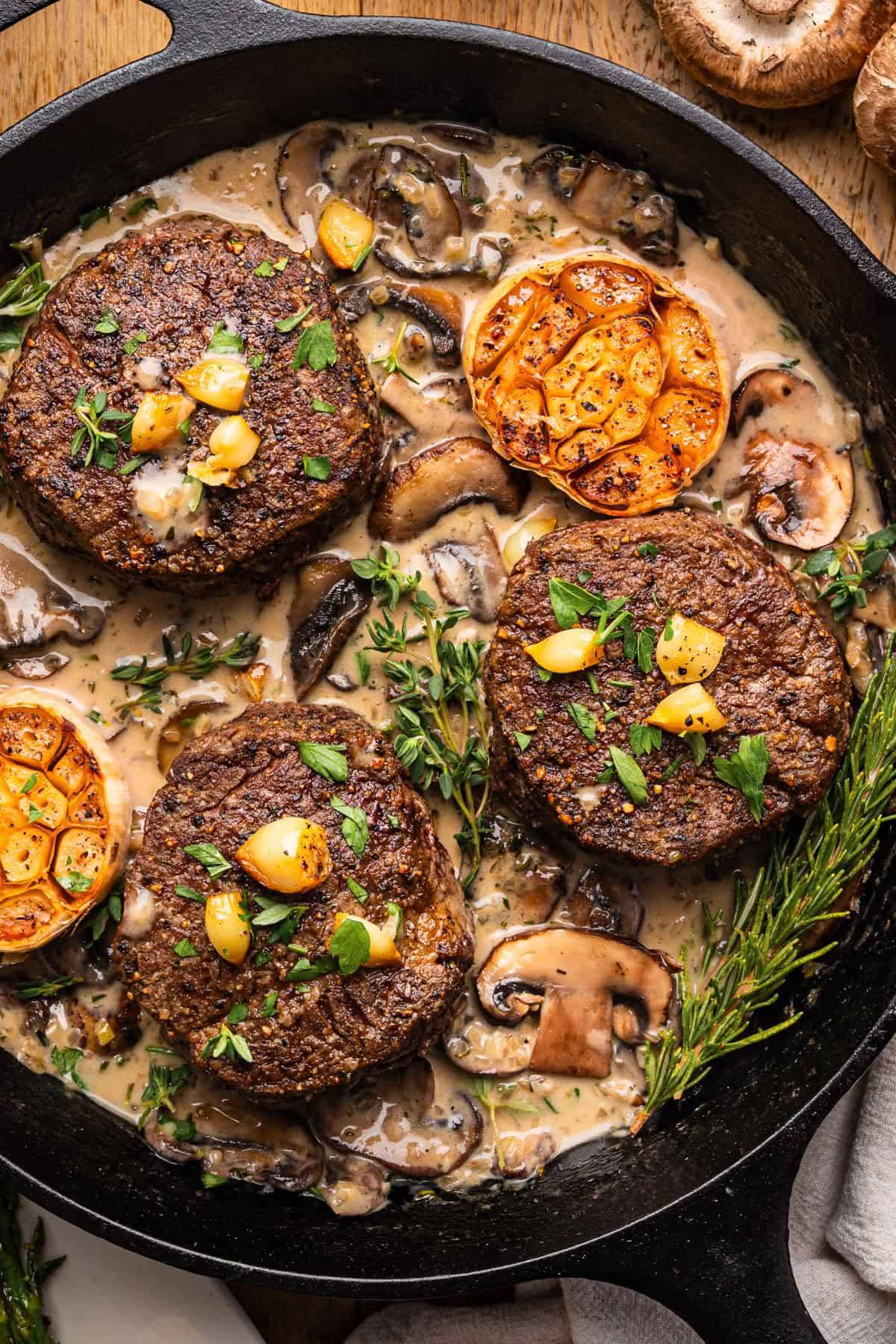 Pan-Seared Filet Mignon with Mushroom Sauce in a cast iron skillet.