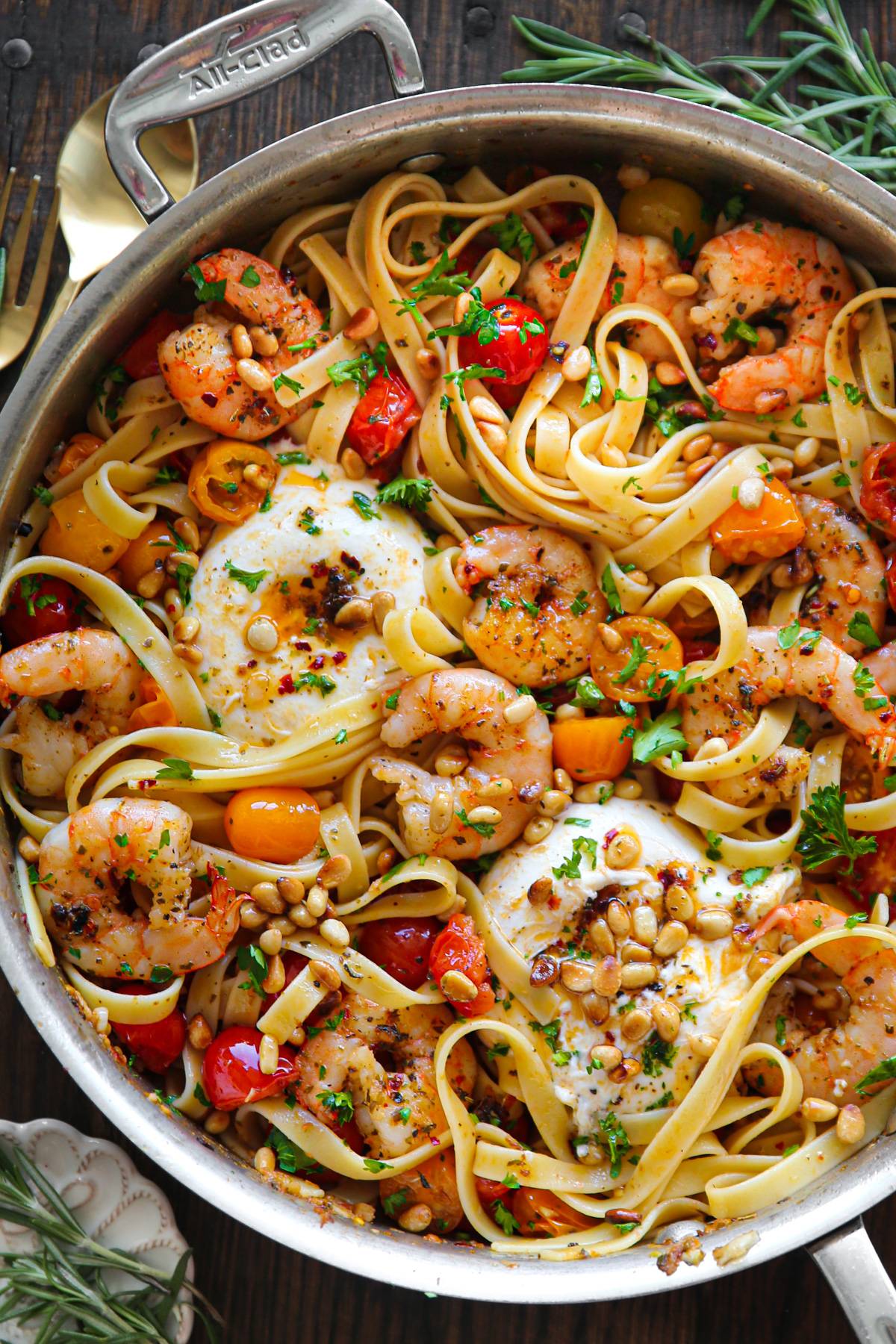 Mediterranean Shrimp Pasta with Tomatoes, Burrata Cheese, and Pine Nuts in a stainless steel pan.