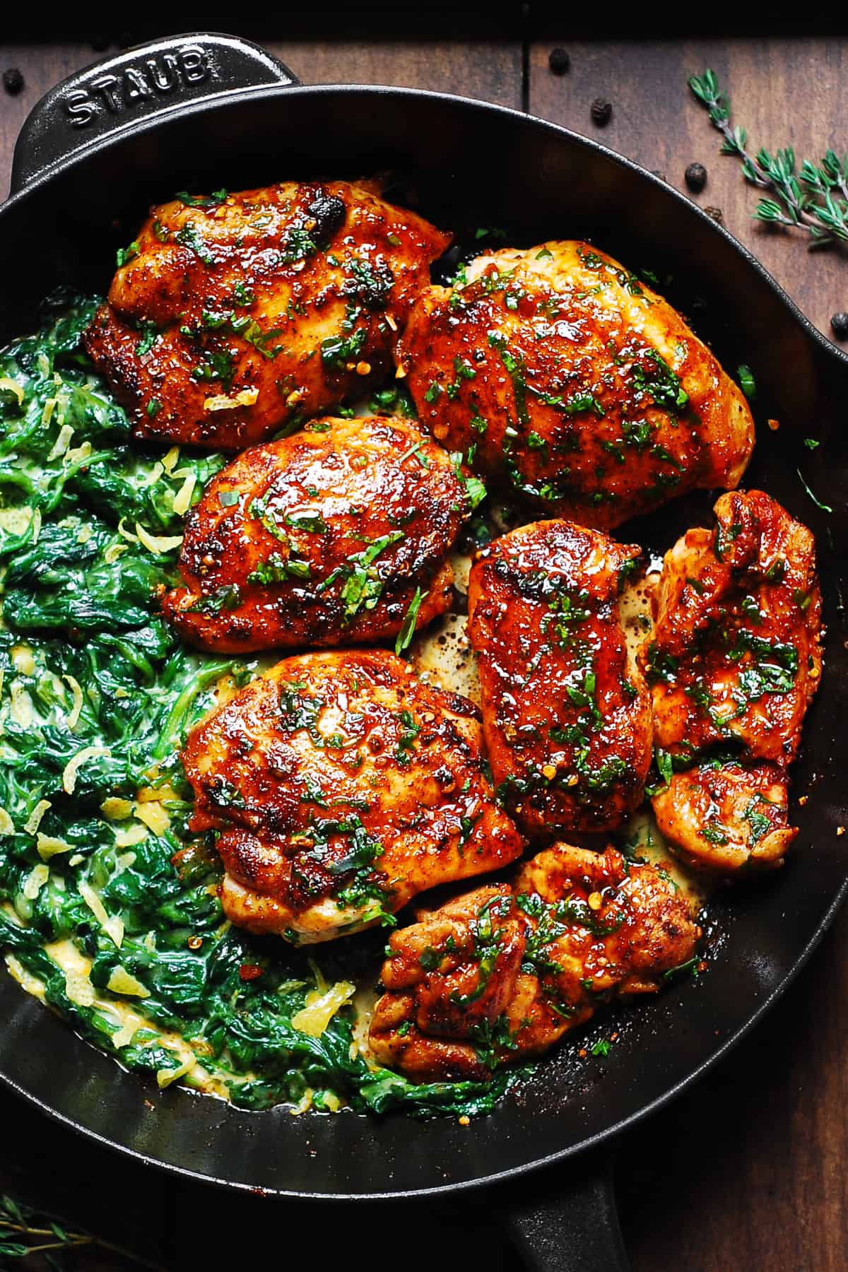 Smoked Paprika Chicken with Creamed Spinach in a cast iron skillet.