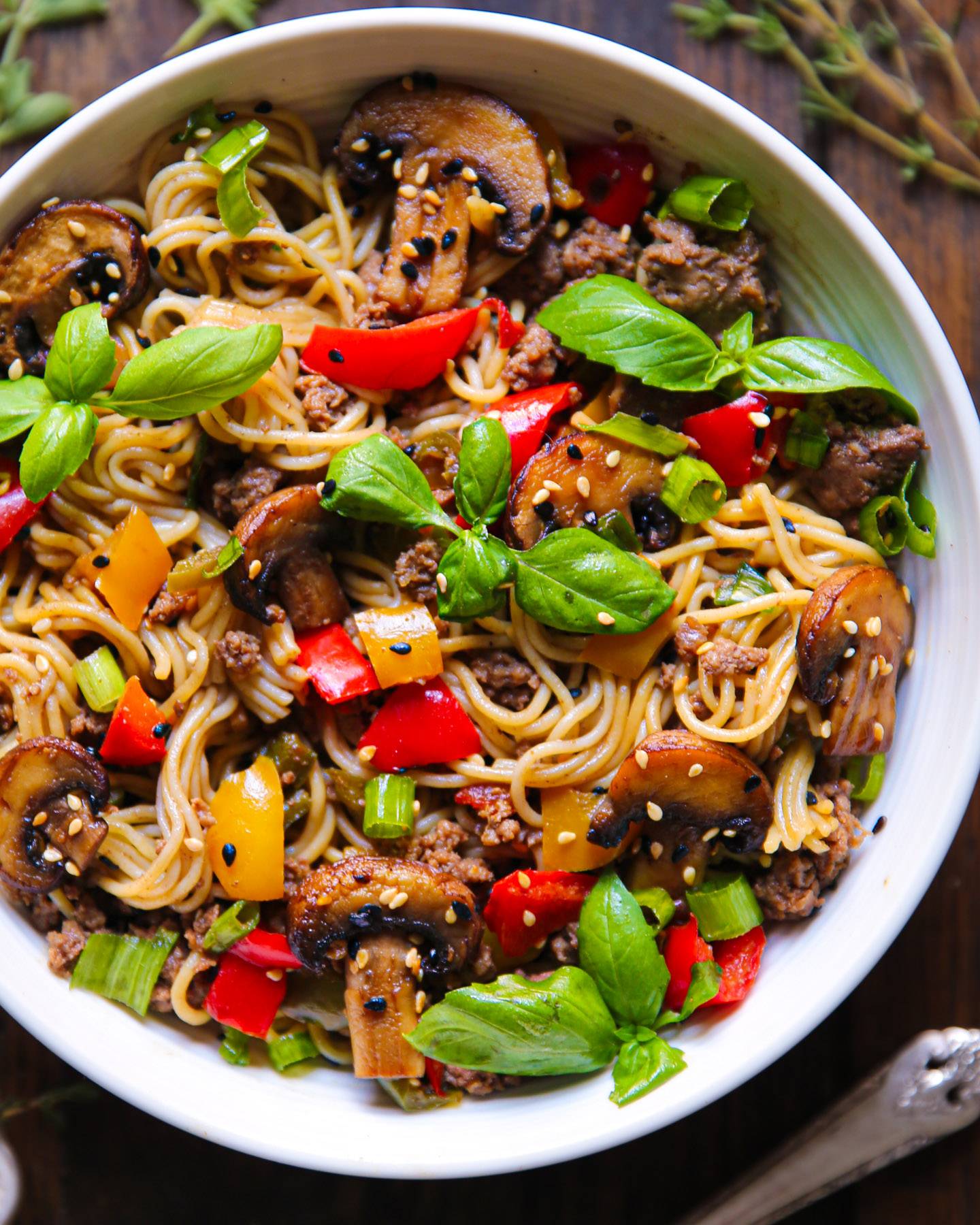 Ground Beef Ramen Noodles with Veggies (Mushrooms, Bell Peppers, Fresh Basil) - in a bowl.