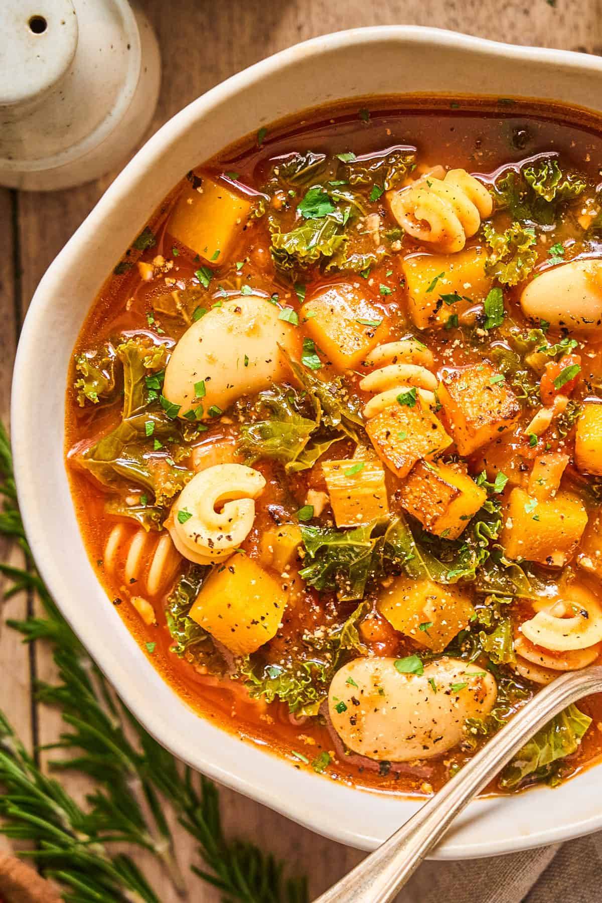 Winter Minestrone Soup with Butternut Squash, Kale, Butter Beans, and Pasta in a bowl.