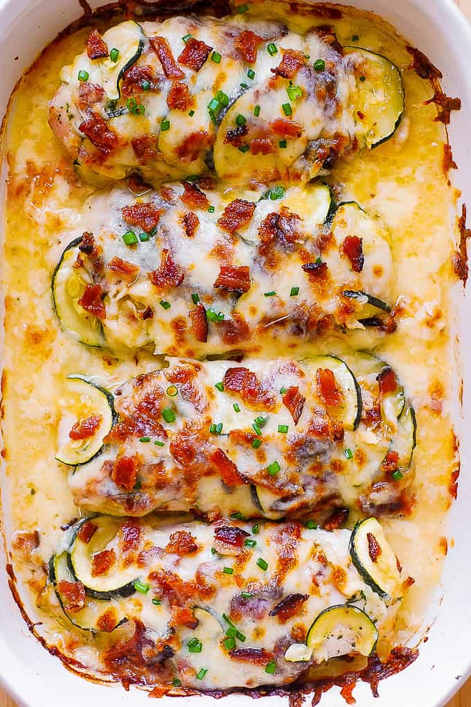 Baked Chicken Breasts with Zucchini, Bacon, Mozzarella, and Parmesan in a white casserole dish.
