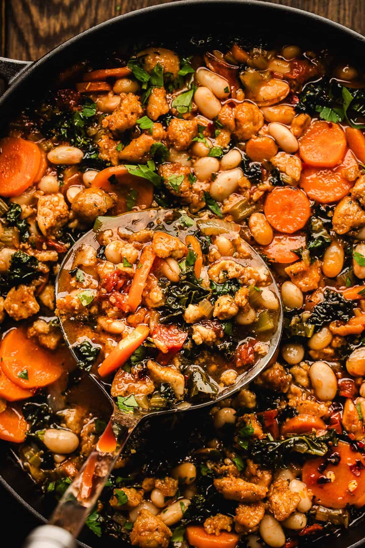 Tuscan White Bean and Sausage Soup in a Dutch oven.