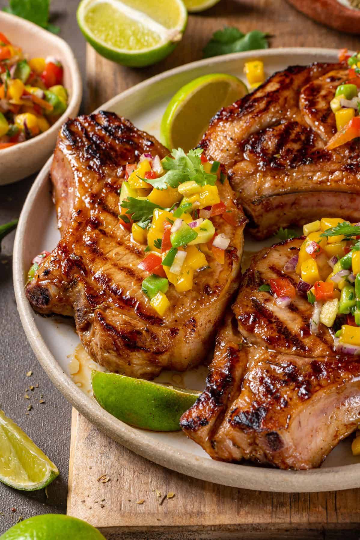 Pork Chops with Mango-Avocado Salsa on a plate.